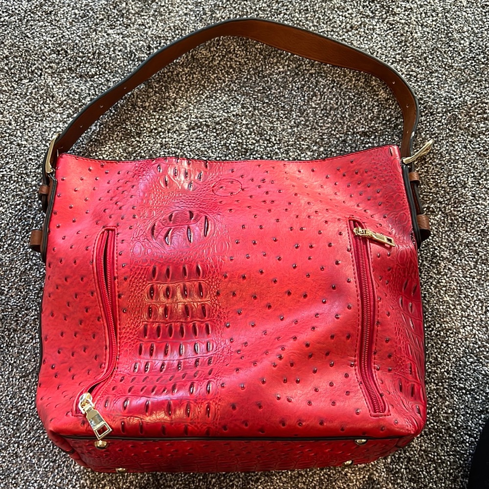 Red purse with a separate clutch bag that can be detached from inside